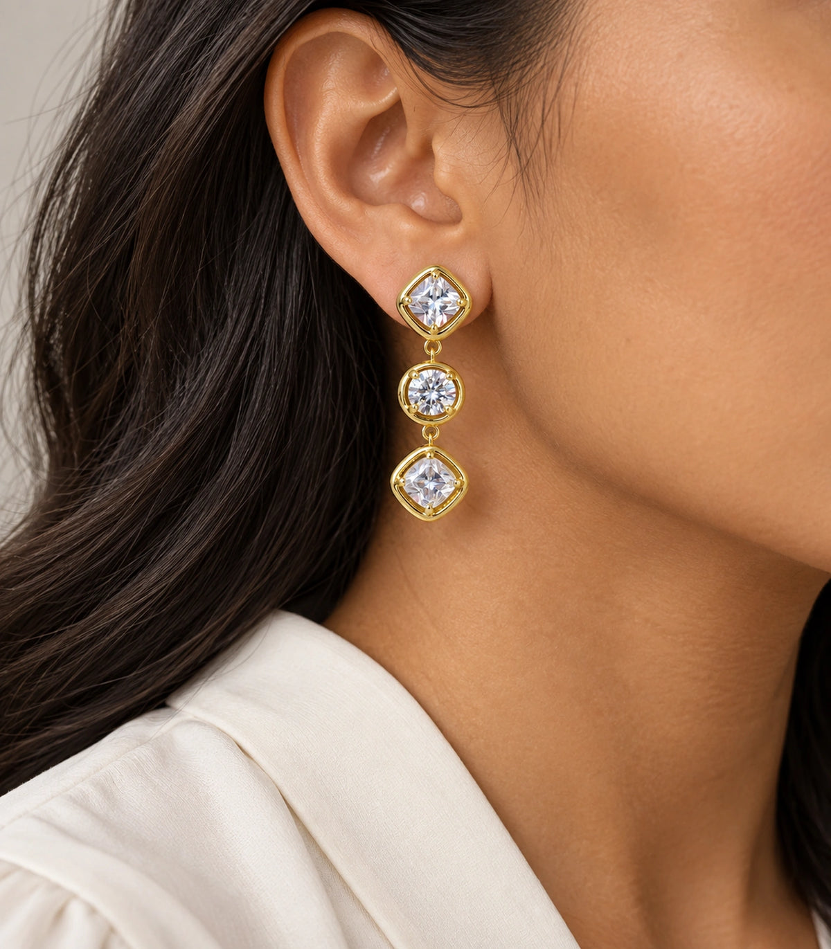 JIMIKI Three Stone Crystal Drop Earring Pair in Gold tone, model wearing view #color_gold tone