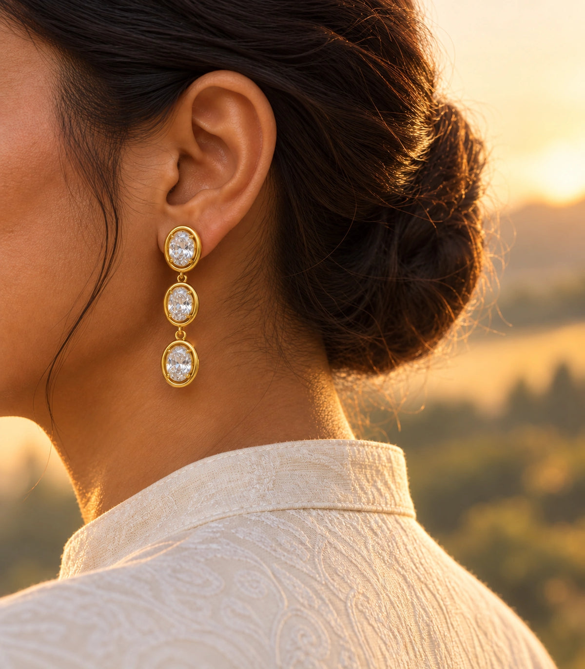 JIMIKI Triple Oval Crystal Drop Earring Pair in Gold tone, editorial model view #color_gold tone
