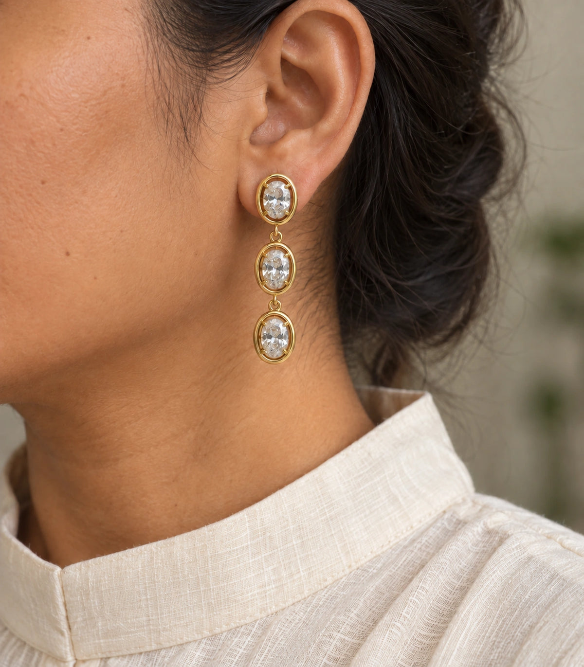 JIMIKI Triple Oval Crystal Drop Earring Pair in Gold tone, model wearing view #color_gold tone