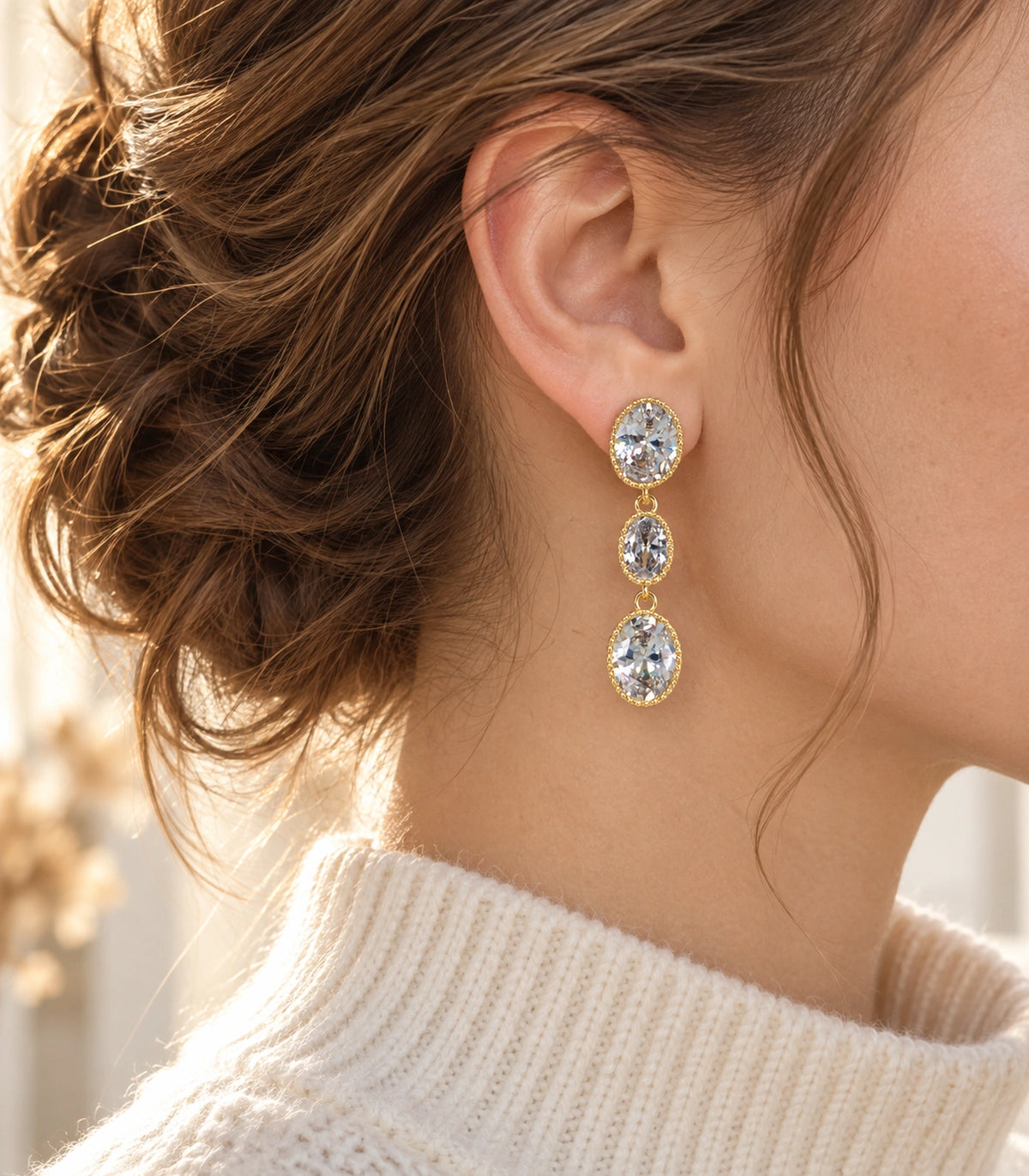 JIMIKI Triple Oval Crystal Drop Earrings in Gold Tone, editorial model view #color_gold tone