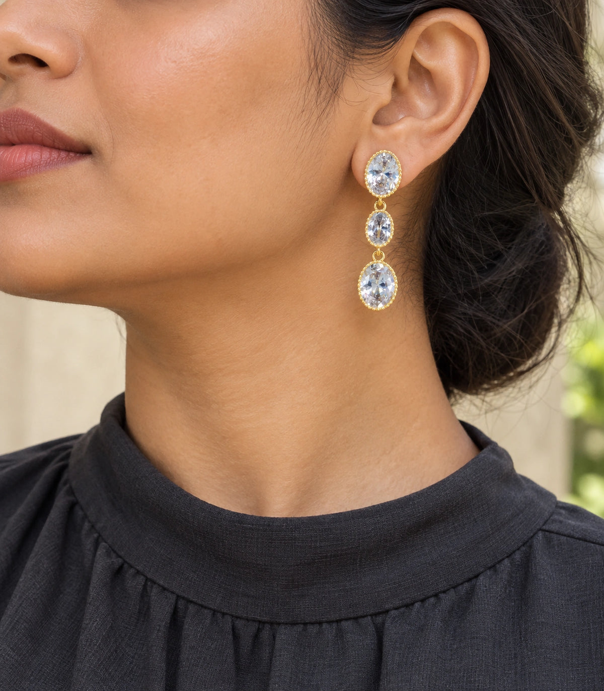 JIMIKI Triple Oval Crystal Drop Earrings in Gold Tone, model wearing view #color_gold tone