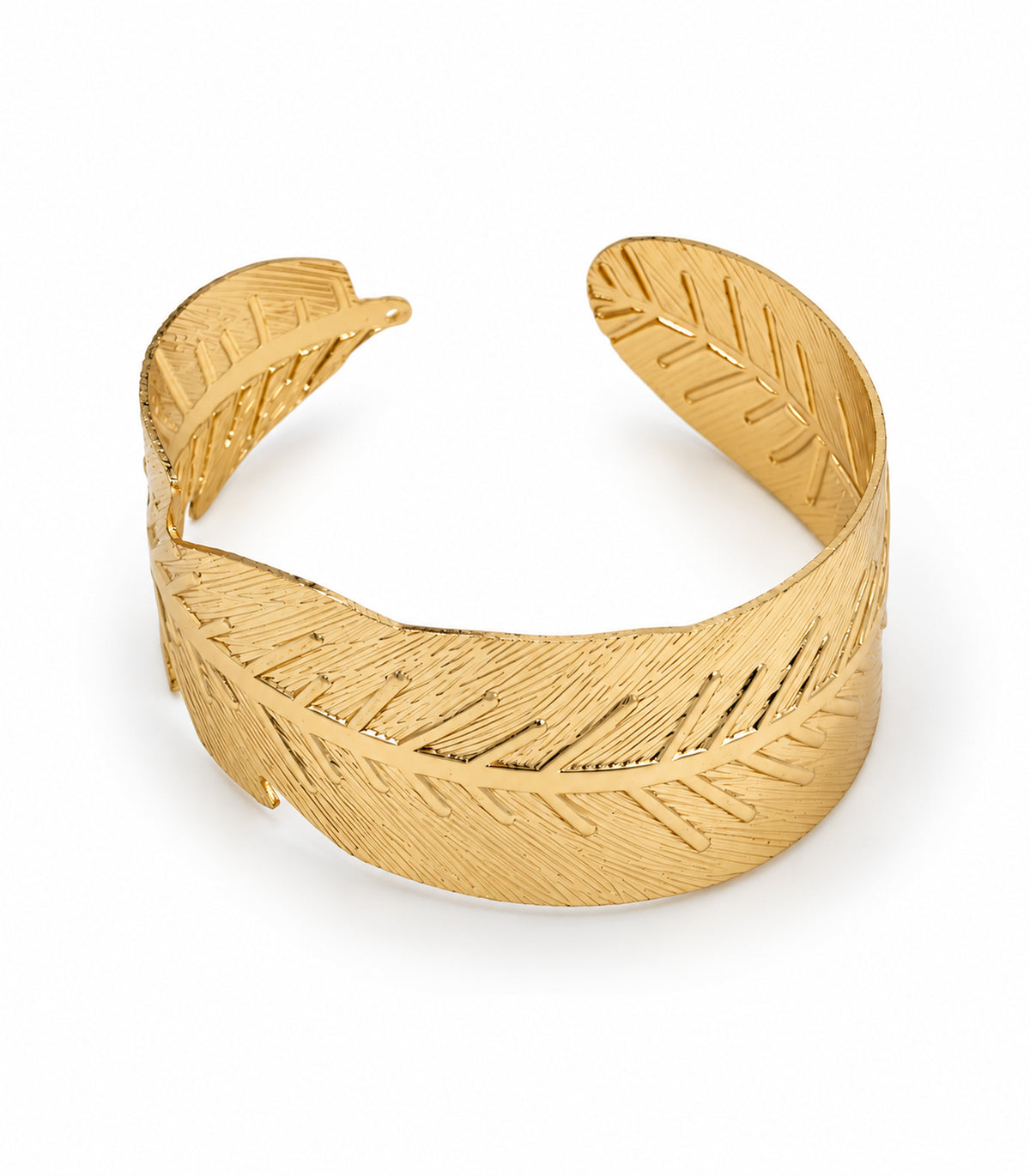 Gold tone wide leaf arm cuff on white, showing the complete open leaf design