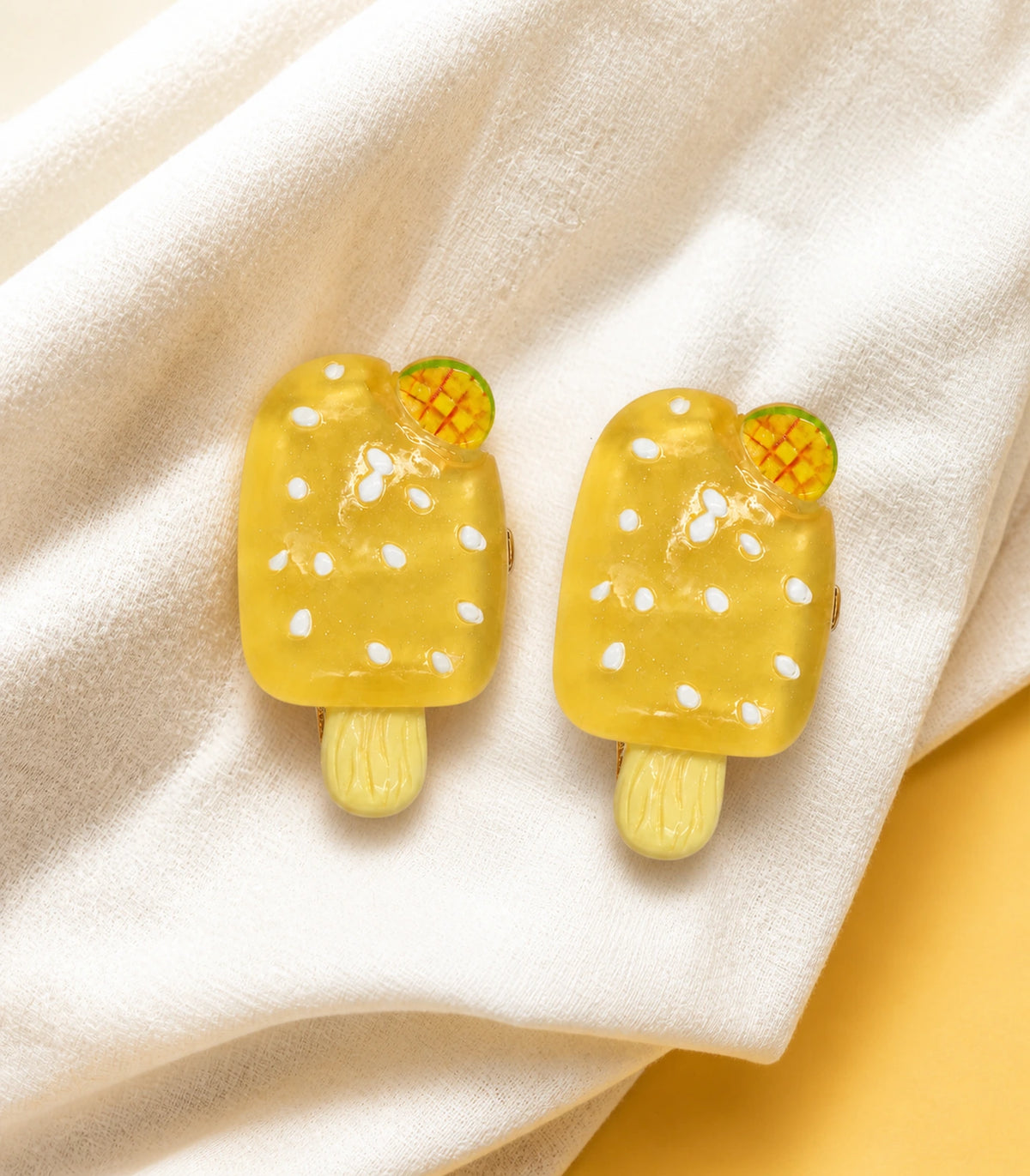Editorial flat lay of the Golden Mango Popsicle Clip Pair