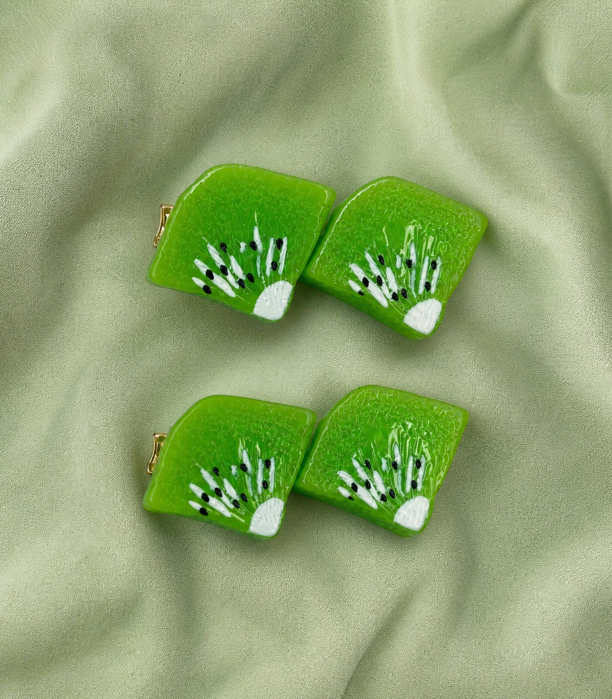 Green Kiwi Duo Clip Pair in an editorial flat lay