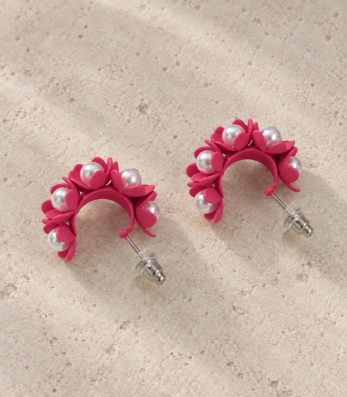 JIMIKI Hot Pink pearl flower hoop earrings, matching pair styled on a light textured surface #color_hot pink