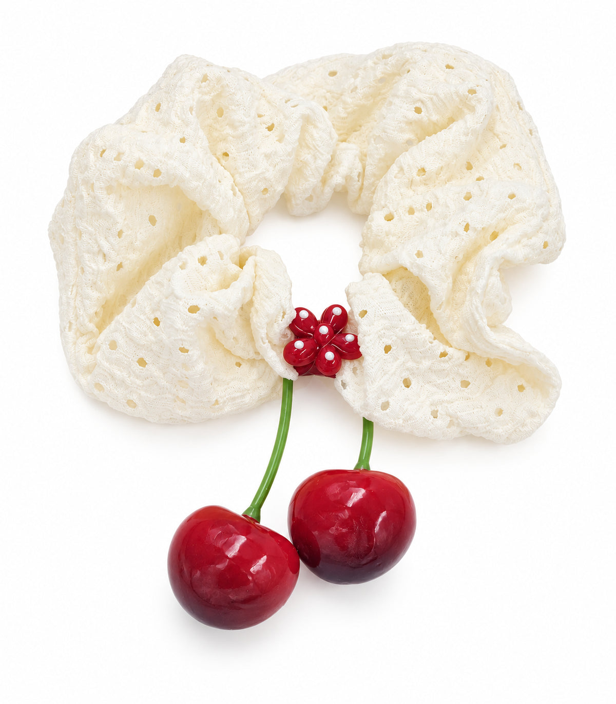 Ivory eyelet cherry scrunchie with dotted red flower centre — white background view