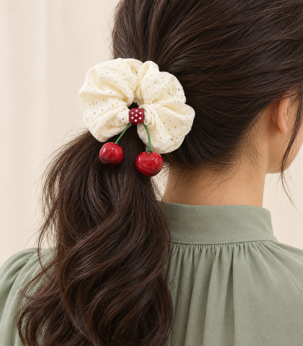 Ivory eyelet cherry scrunchie with dotted square centre, model