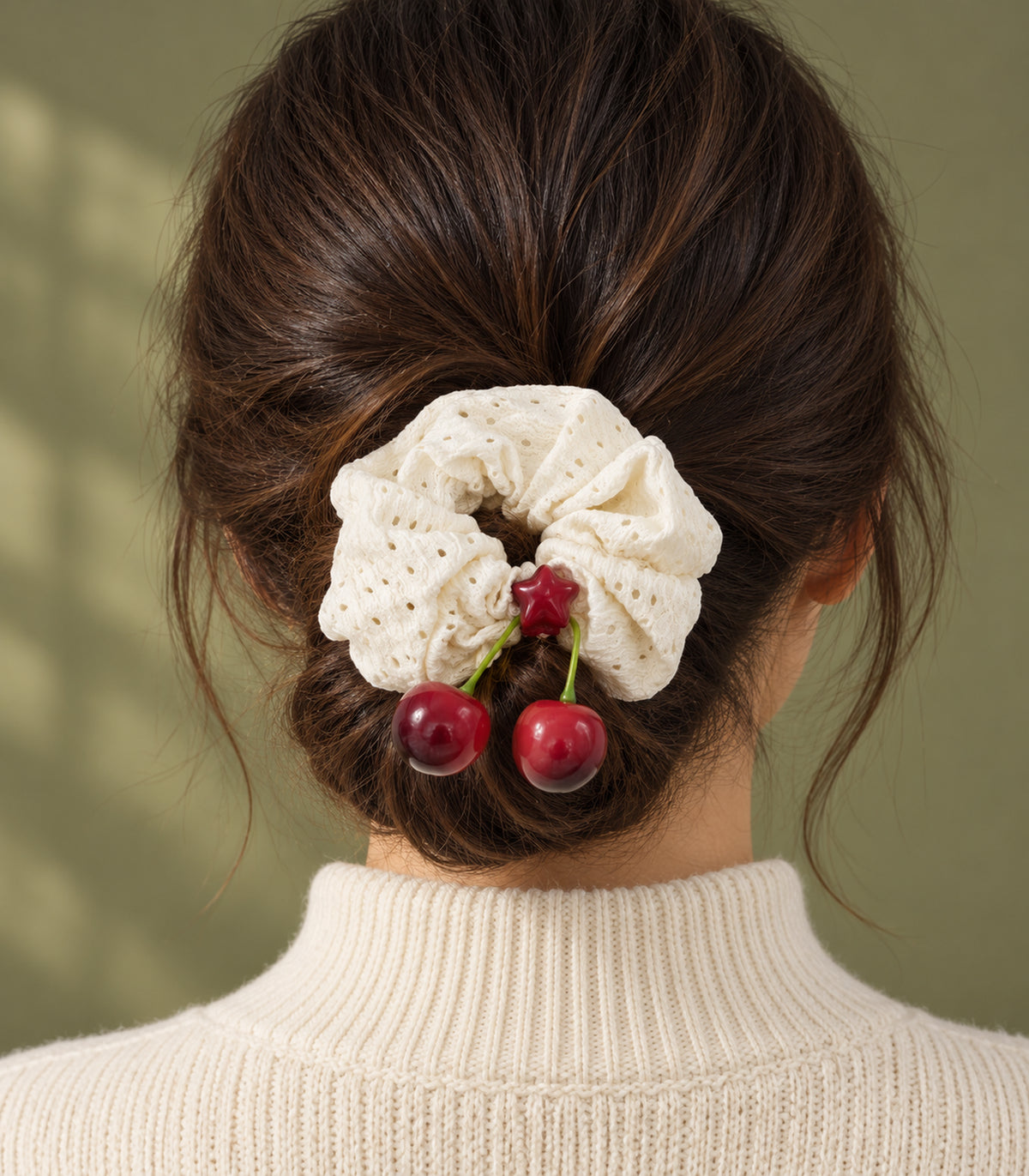 Ivory eyelet cherry scrunchie with red star centre — editorial model