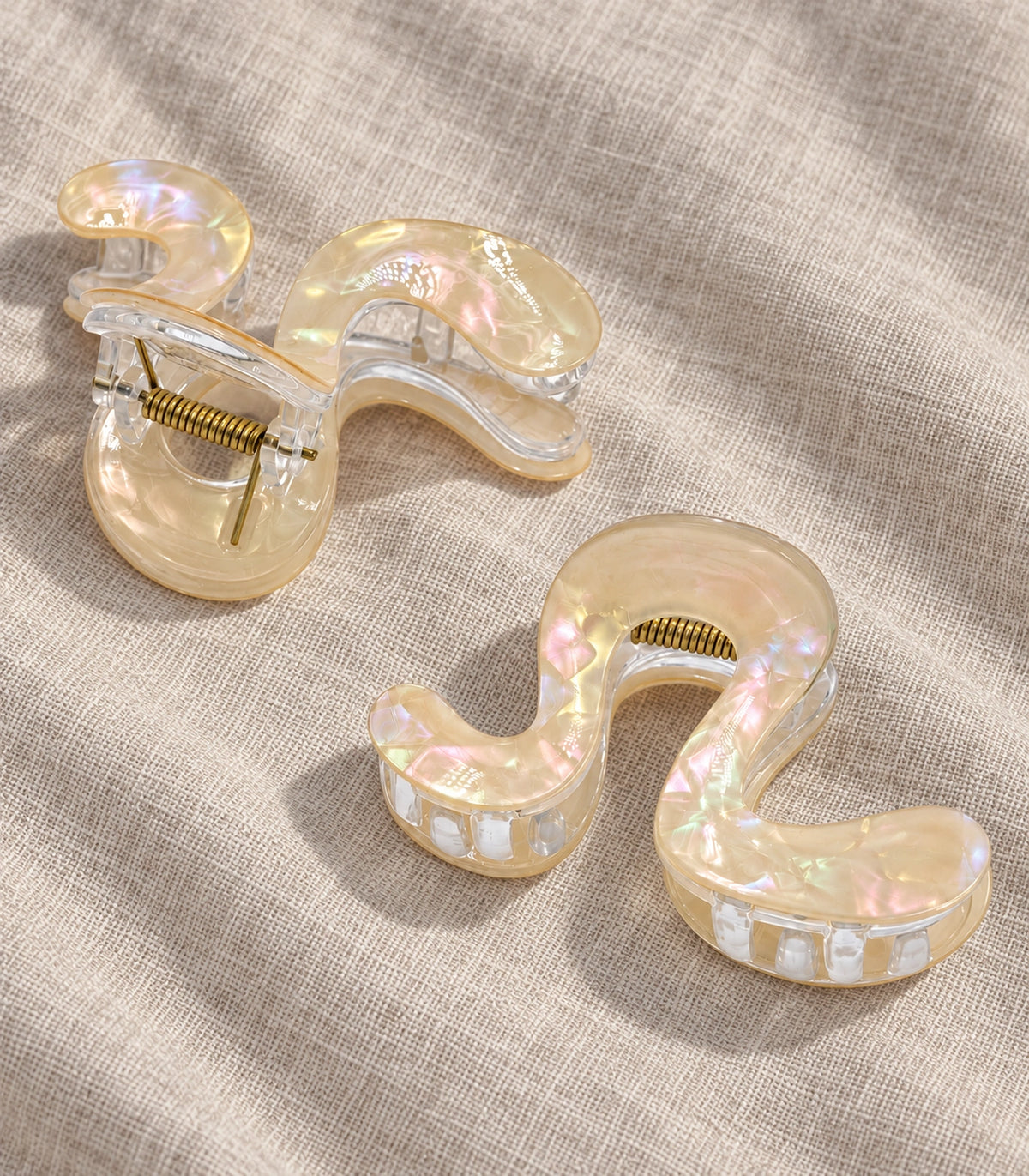 JIMIKI Iridescent S Shaped Hair Claw Clips in Ivory, editorial flat lay #color_ivory