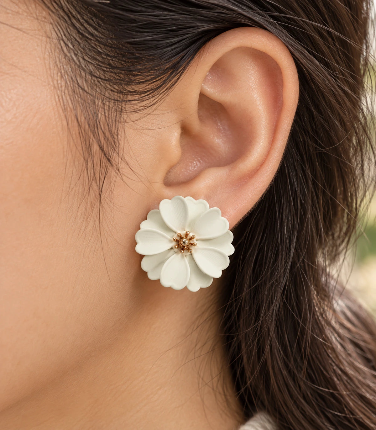 JIMIKI Ivory Layered Daisy Stud Earrings - layered scalloped petals and gold-tone centre worn close-up #color_ivory