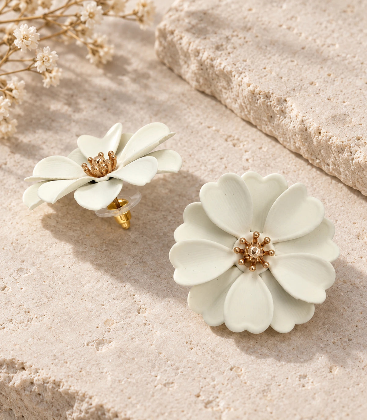 JIMIKI Ivory Layered Daisy Stud Earrings - pair in styled flatlay #color_ivory