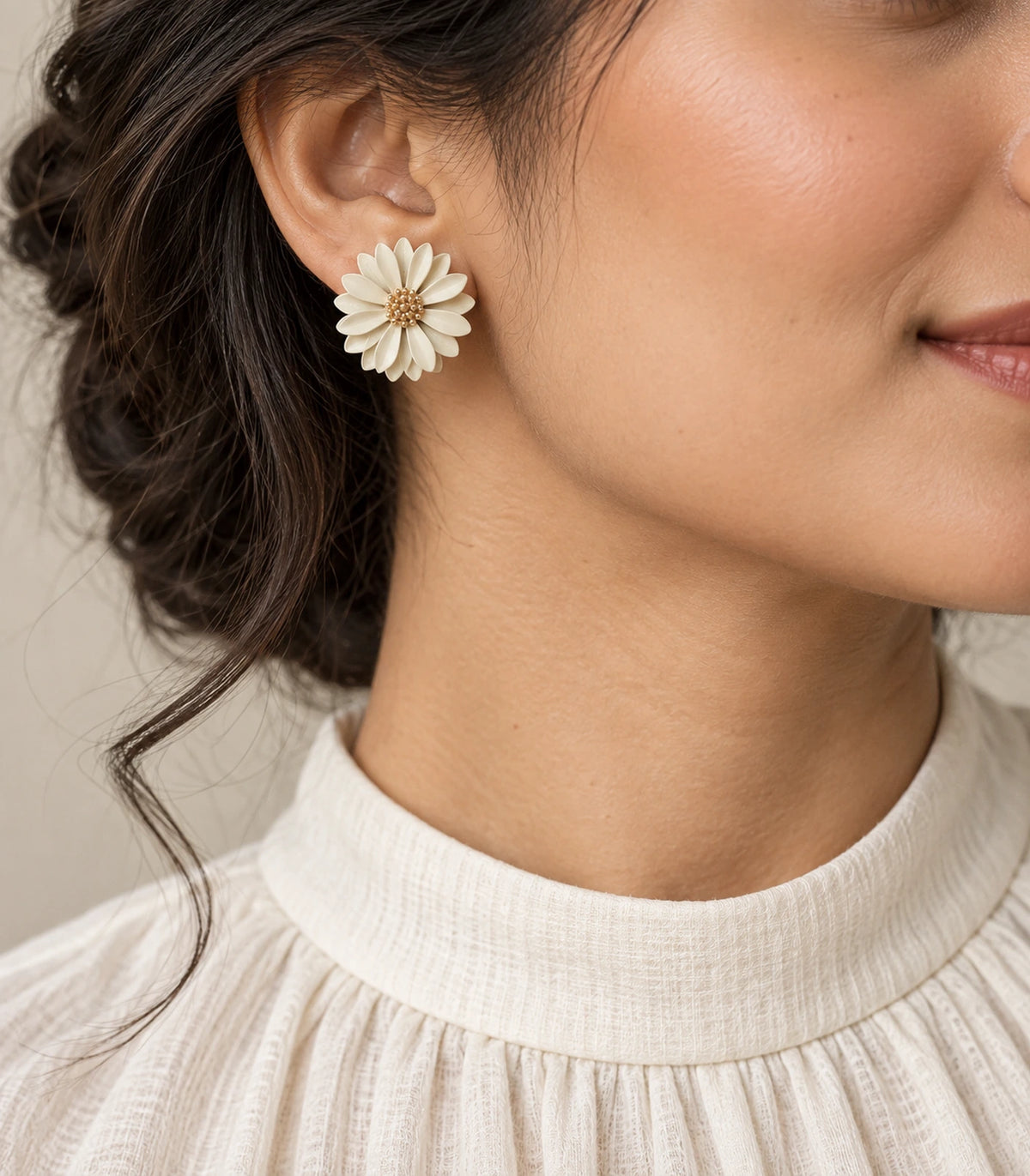 JIMIKI Ivory layered starburst daisy stud earrings, editorial portrait of the daisy stud worn at the ear #color_ivory