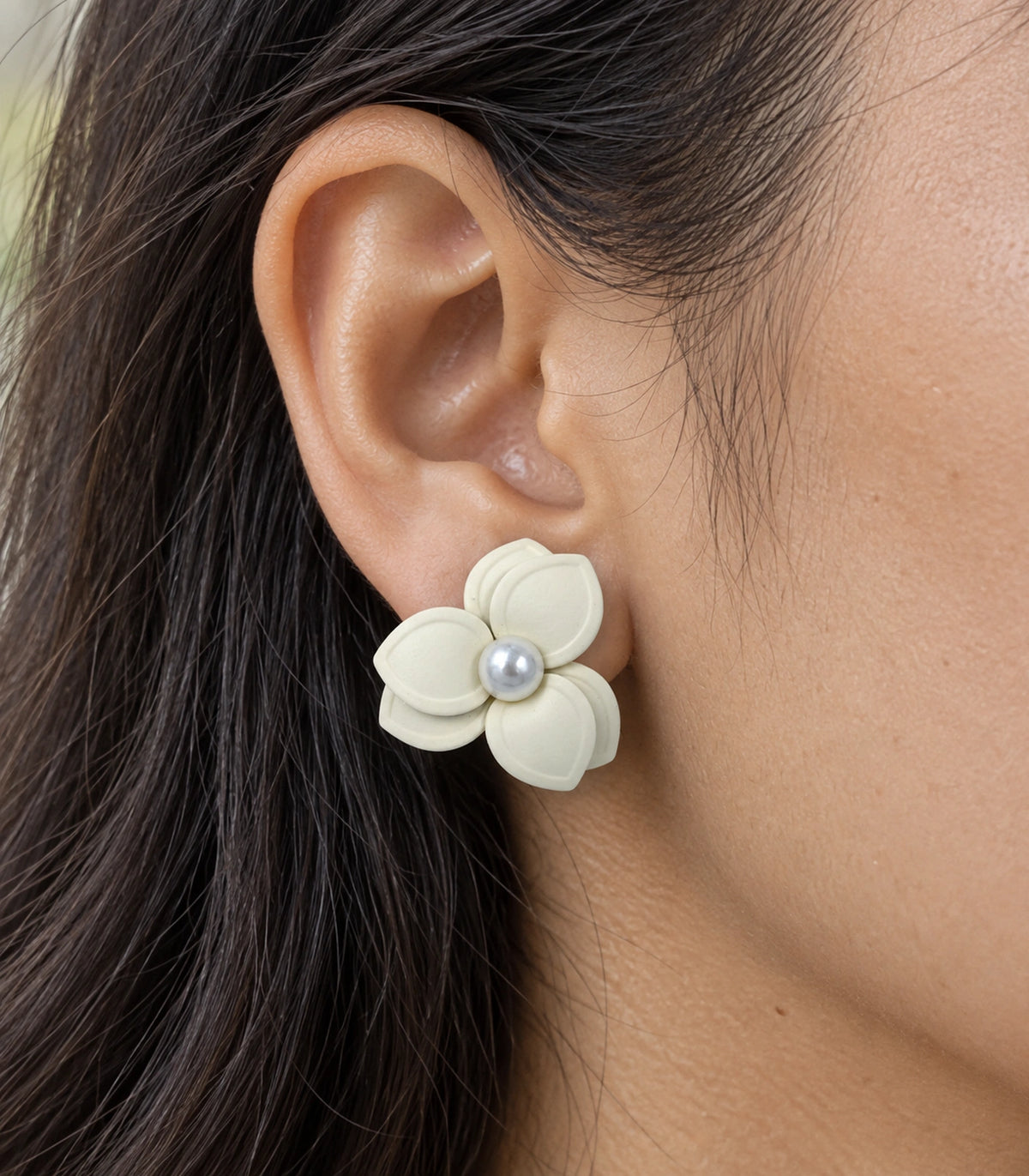 JIMIKI Ivory Triple Petal Pearl Flower Stud Earrings - worn detail of layered petals and pearl-style centre #color_ivory
