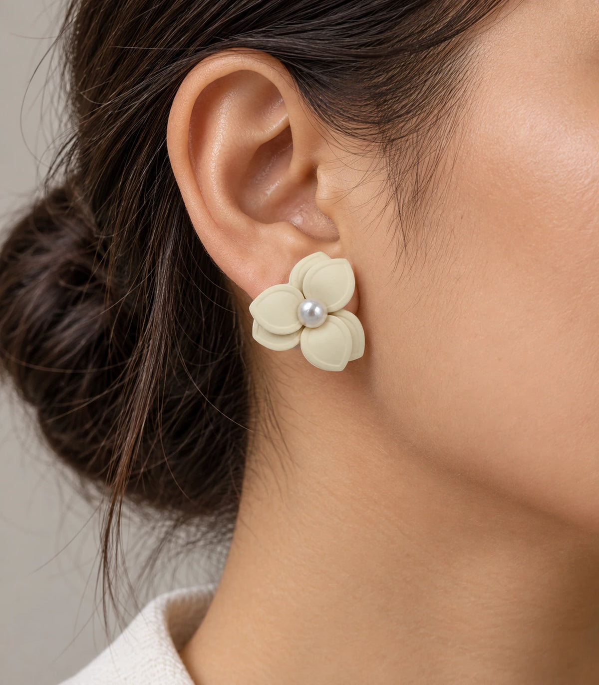 JIMIKI Ivory Triple Petal Pearl Flower Stud Earrings - one complete ivory earring worn naturally #color_ivory