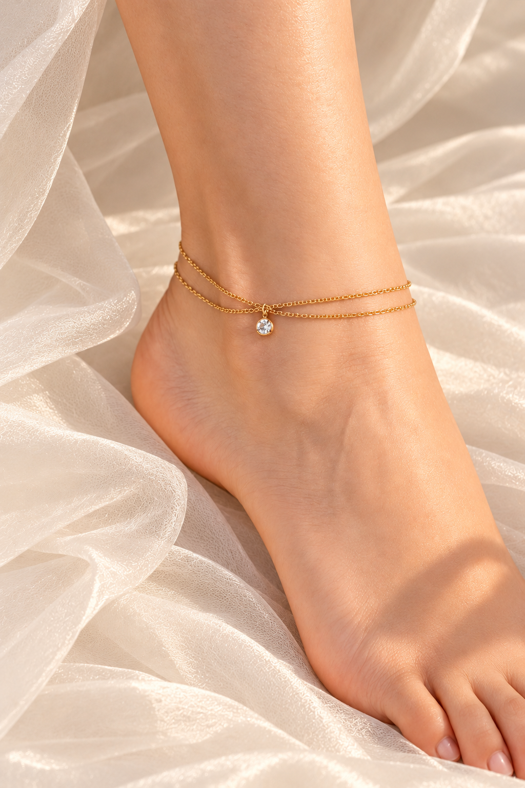 Gold anklet on ivory fabric