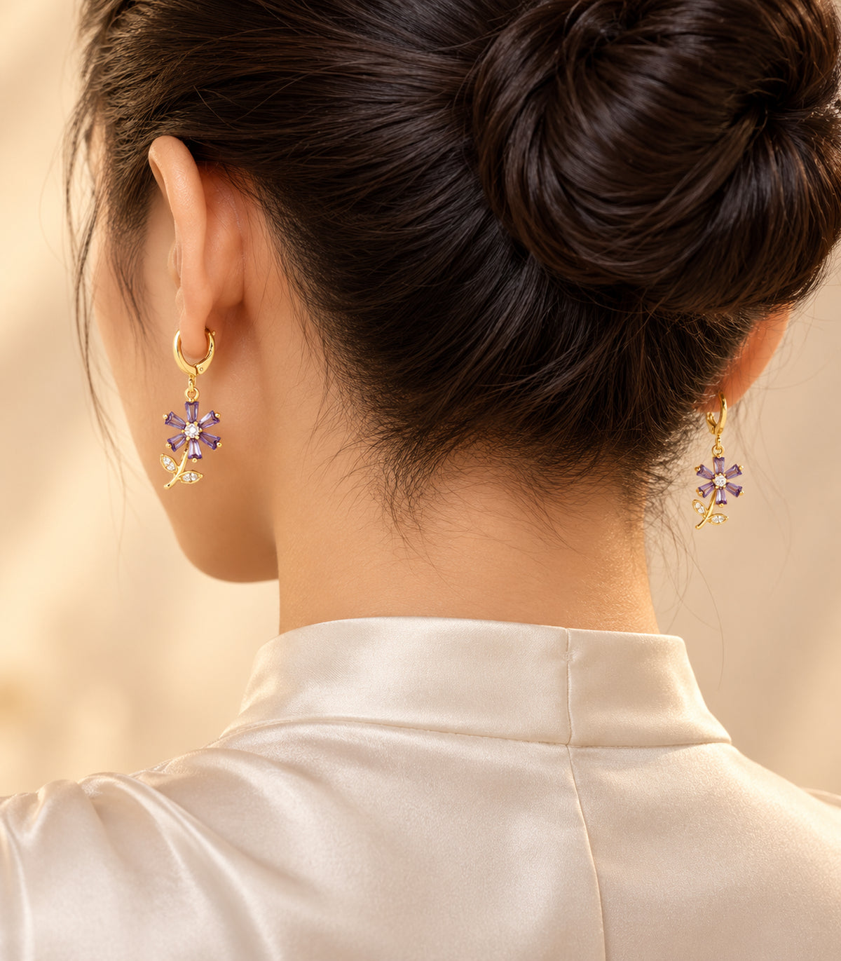 Selected pair from the gold-tone three-pair charm hoop earring set, editorial worn view
