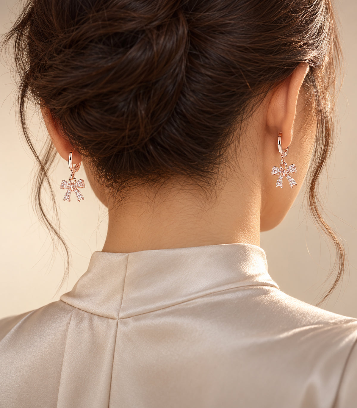 Editorial wearing view of an included rose gold tone hoop earring pair
