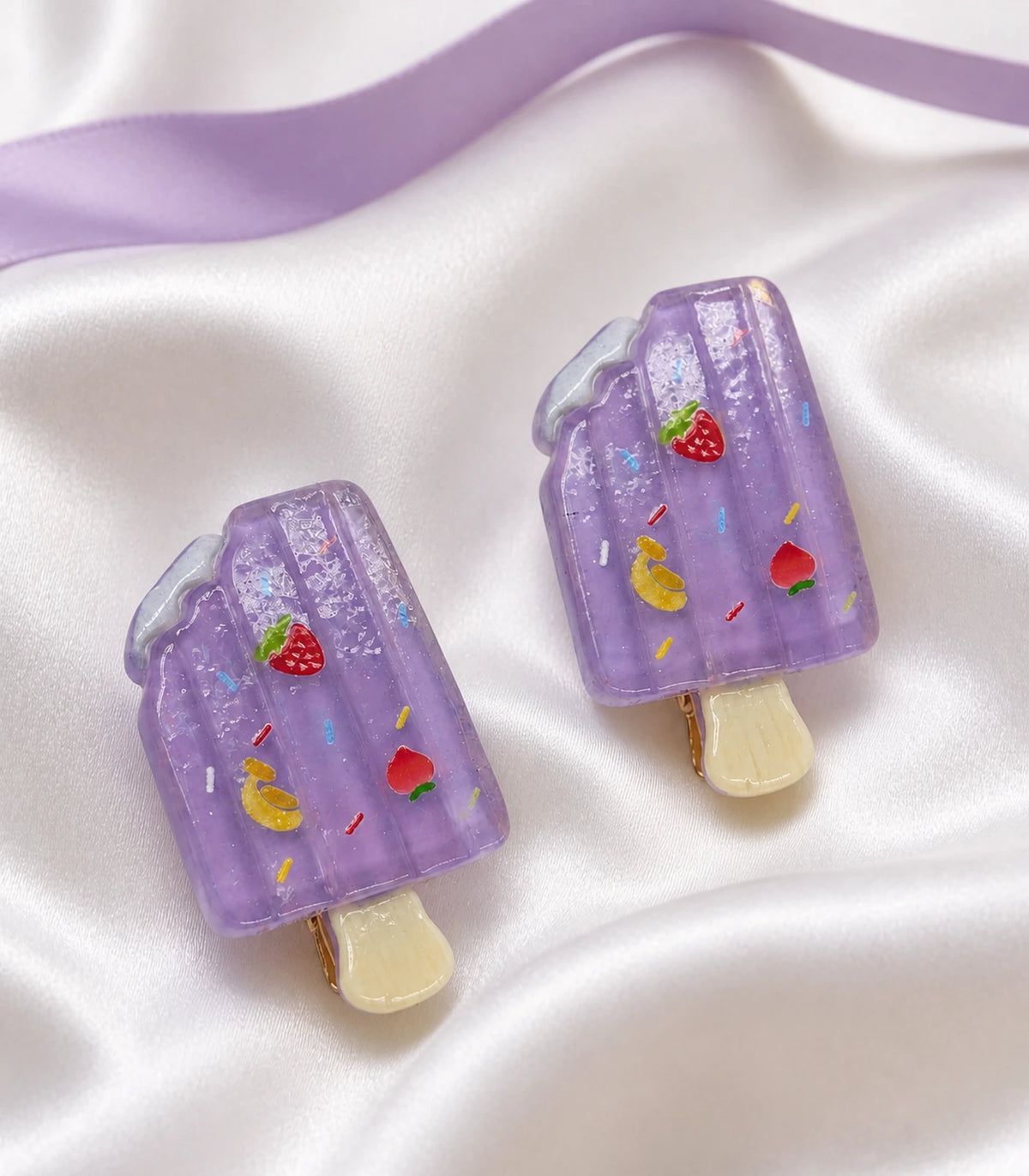 Editorial flat lay of the Lavender Fruit Sprinkle Popsicle Clip Pair