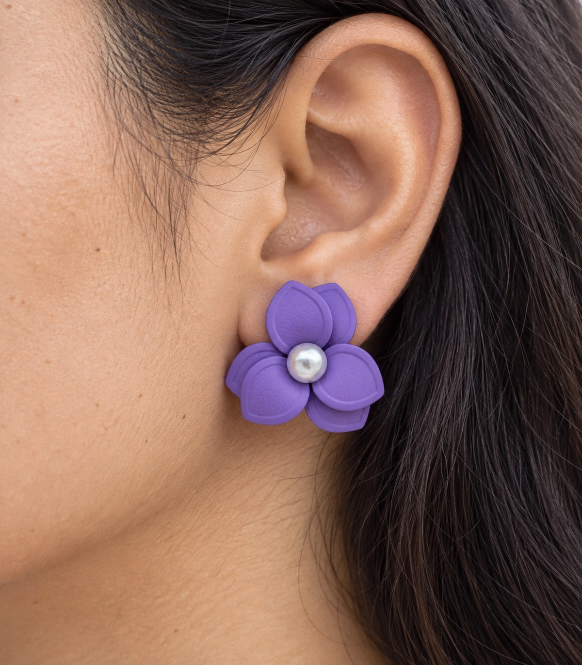 JIMIKI Lavender Triple Petal Pearl Flower Stud Earrings - layered petals and pearl-style centre worn close-up #color_lavender