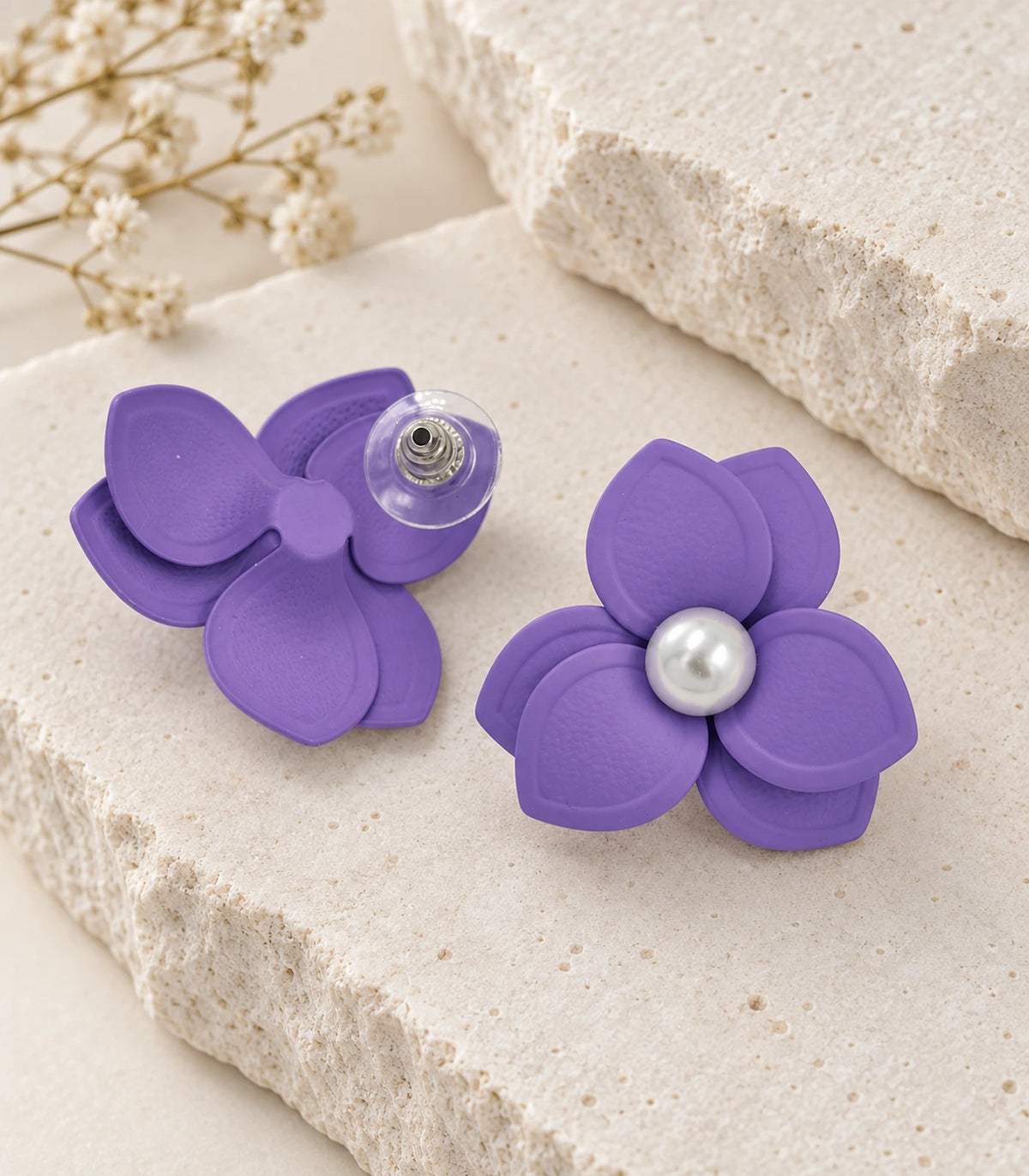 JIMIKI Lavender Triple Petal Pearl Flower Stud Earrings - pair in styled flat lay #color_lavender