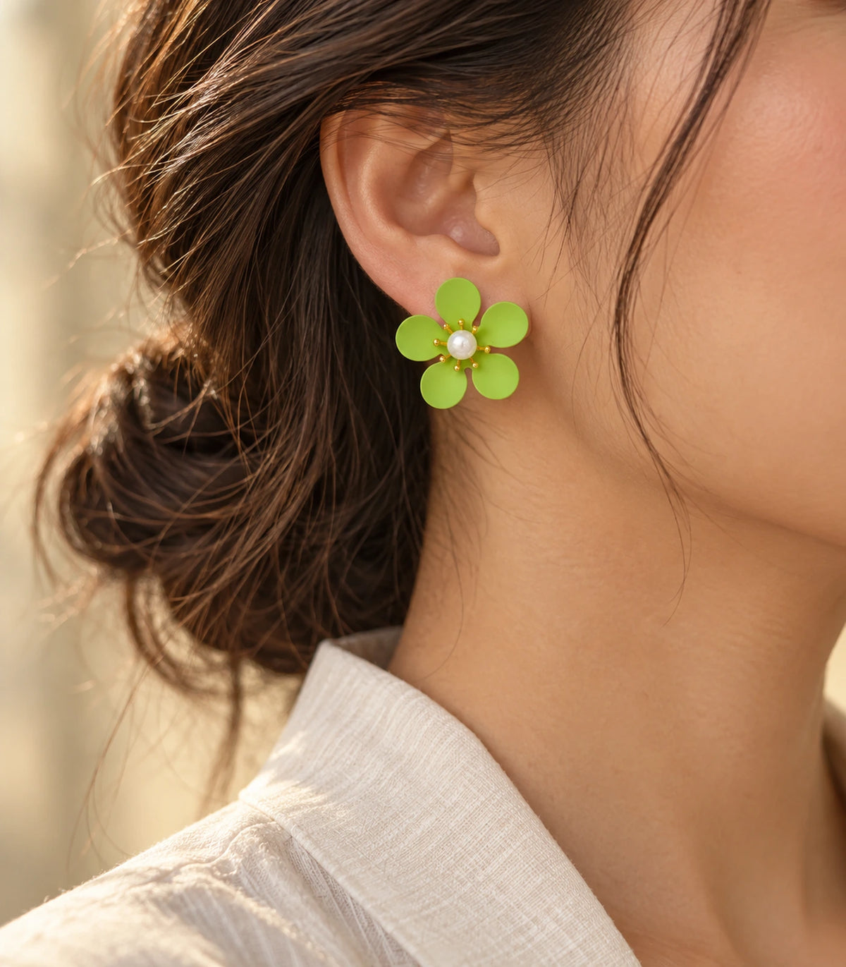 JIMIKI lime five-petal flower stud earrings with pearl-effect centre, alternate styled worn view of flower stud #color_lime