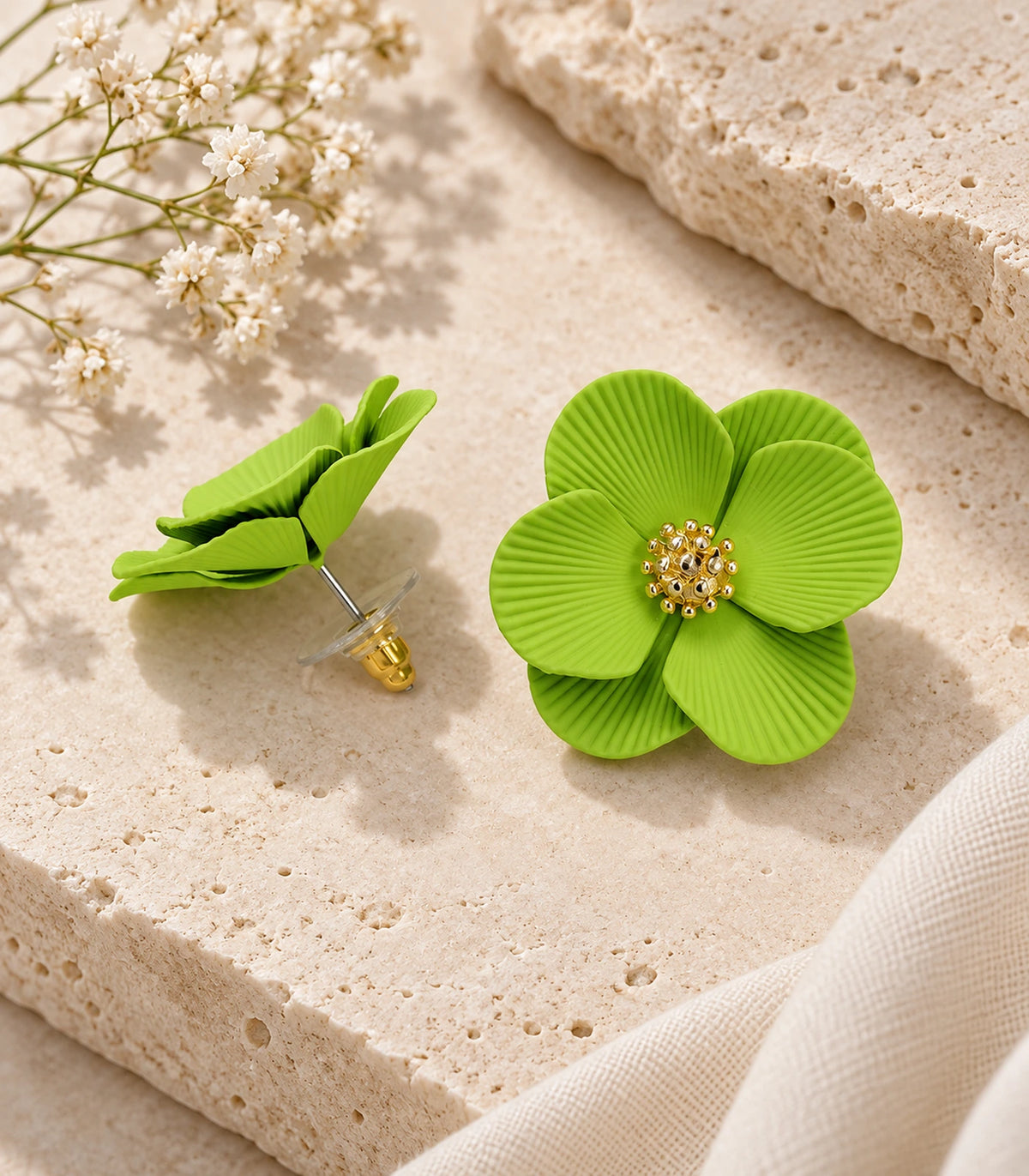 JIMIKI Lime ribbed flower stud earrings, pair arranged in an editorial flat lay #color_lime