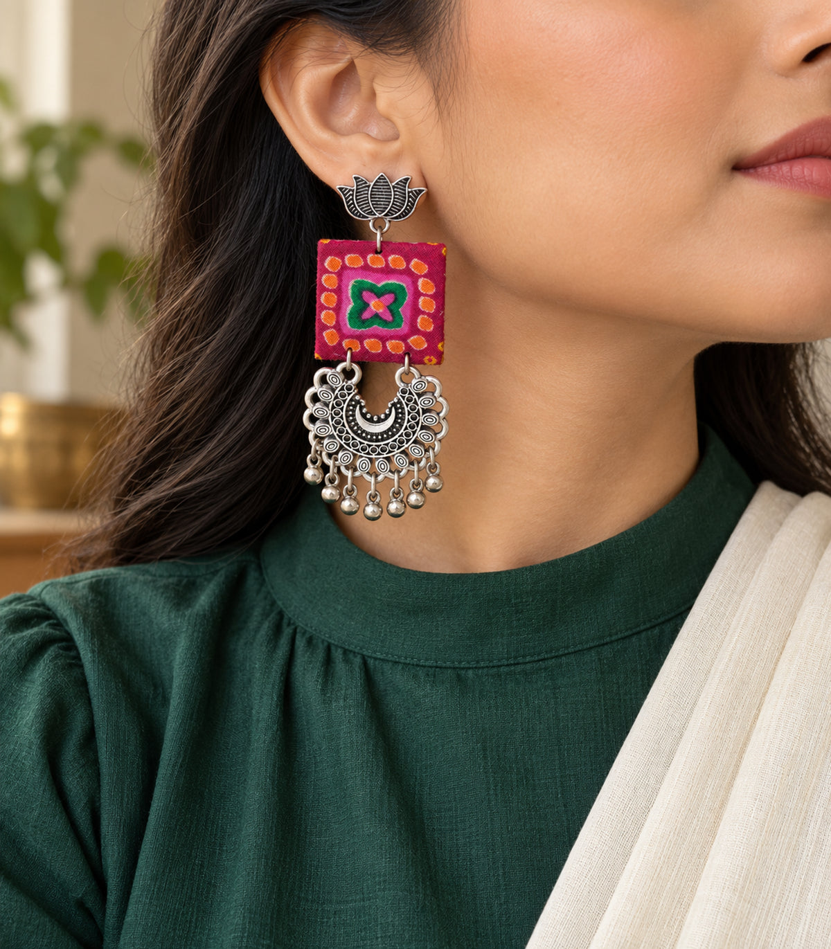 Magenta and green lotus crescent fabric earrings - editorial model view
