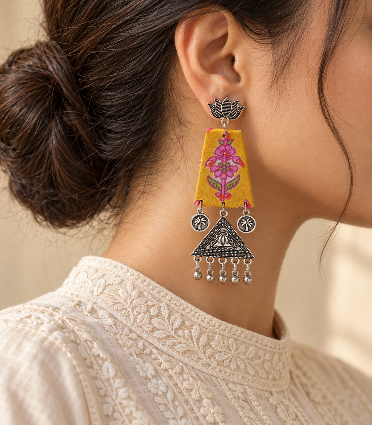 Mustard floral fabric lotus triangle earrings - editorial-model worn view of one earring