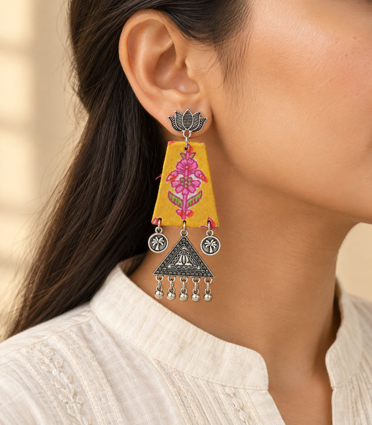 Mustard floral fabric lotus triangle earrings - model worn view of one earring