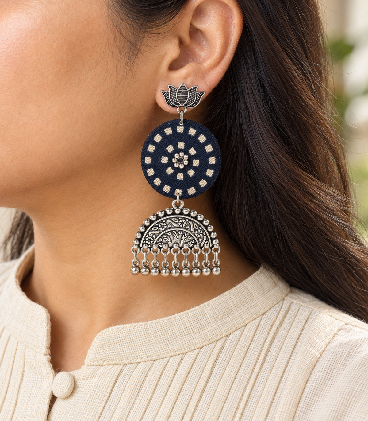 Navy and ivory lotus bell fringe fabric earrings — closeup view