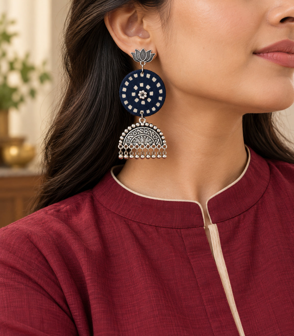 Navy and ivory lotus bell fringe fabric earrings — editorial model view