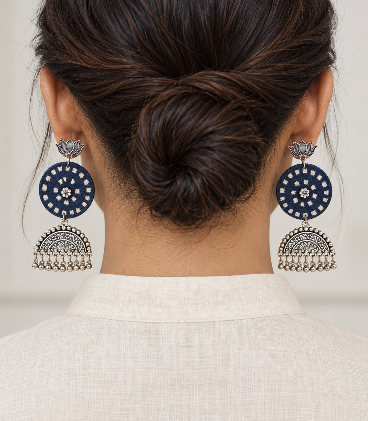 Navy and ivory lotus bell fringe fabric earrings — model view