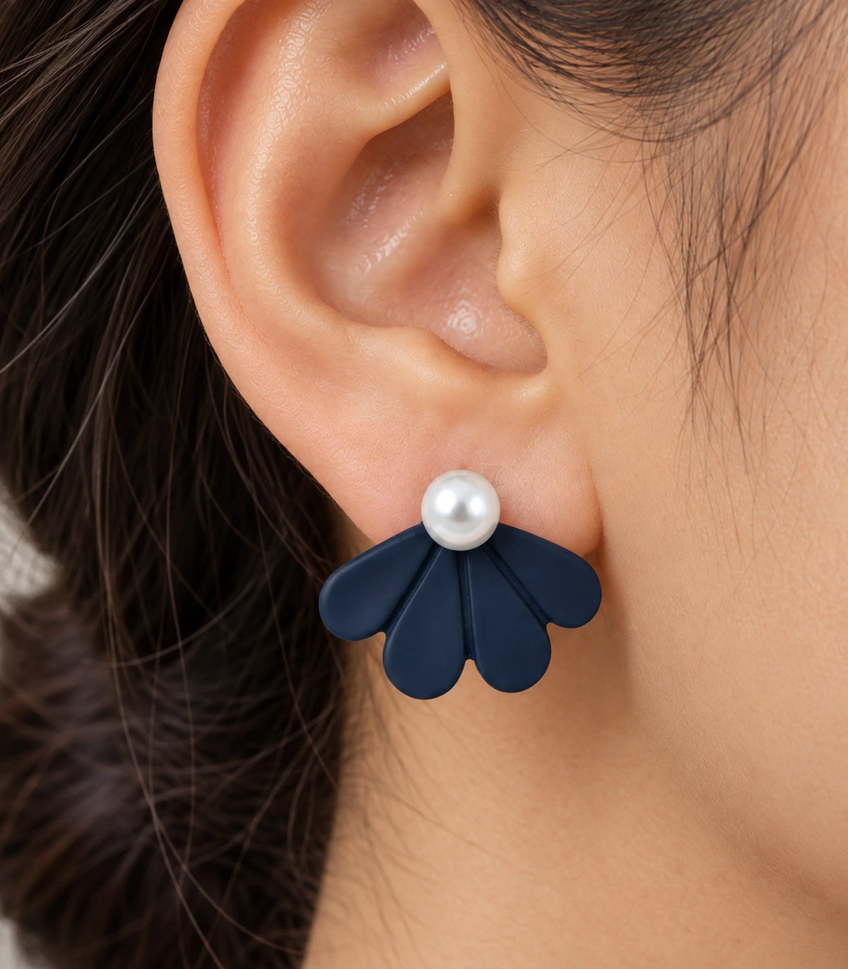 JIMIKI Navy pearl fan petal stud earrings, worn closeup of four petals and pearl-style bead #color_navy