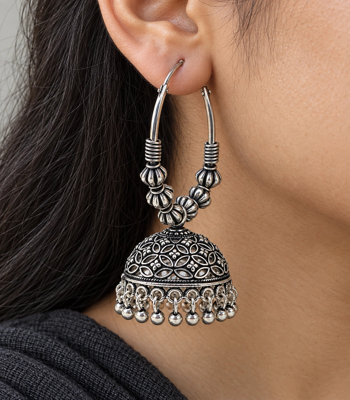 JIMIKI Oxidized Silver Floral Lattice Hoop Jhumka Earrings - Oxidized Silver close-up of earring worn on the ear #color_oxidized-silver