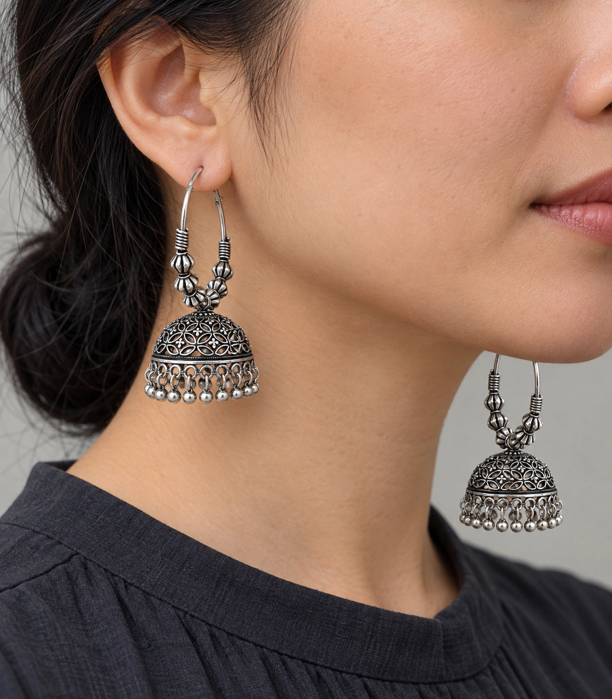 JIMIKI Oxidized Silver Floral Lattice Hoop Jhumka Earrings - Oxidized Silver earring worn by a model #color_oxidized-silver