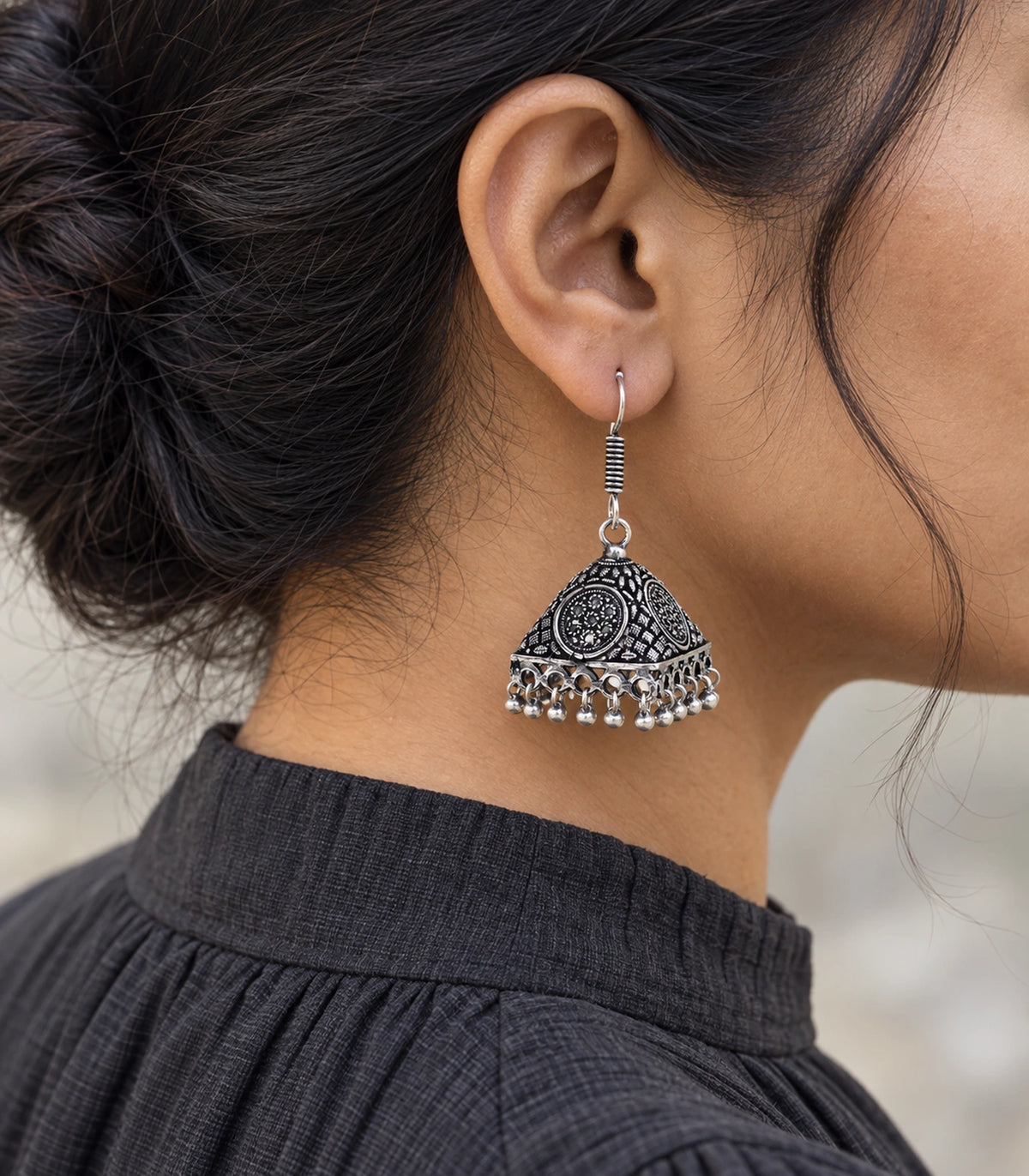 JIMIKI Oxidized Silver Floral Medallion Pyramid Jhumka Earrings - Editorial worn view #color_oxidized-silver