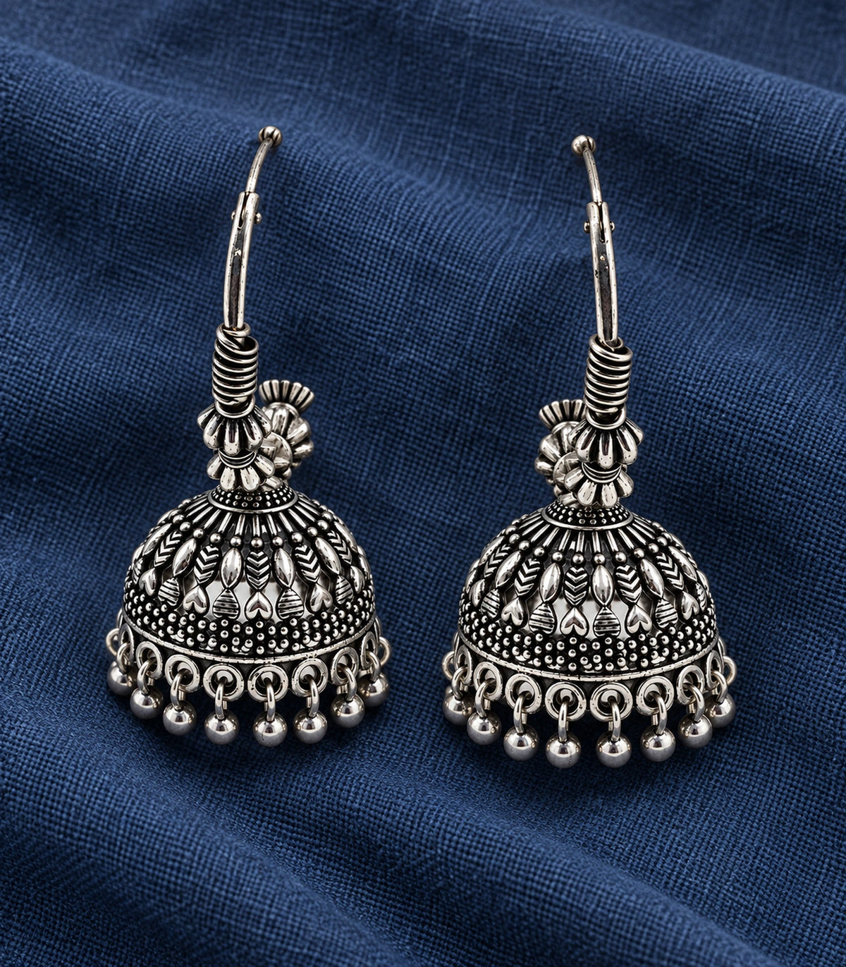 JIMIKI Oxidized Silver Leaf Chevron Hoop Jhumka Earrings - styled flatlay of the matching earrings #color_oxidized-silver
