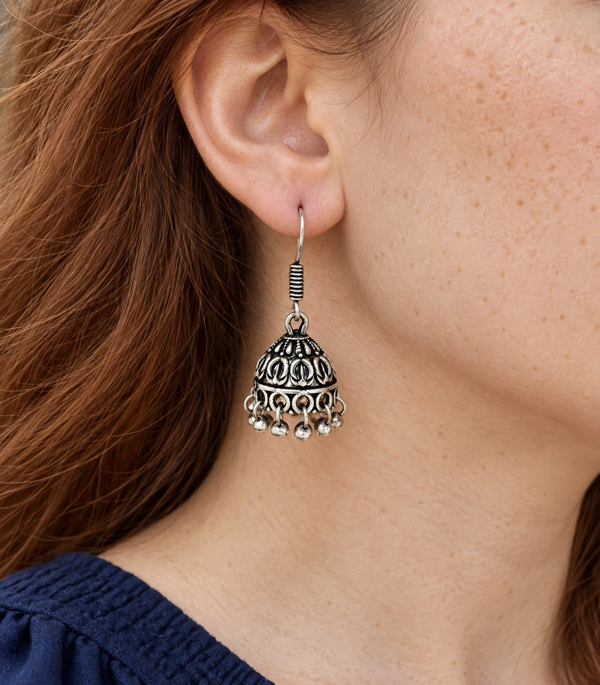 JIMIKI Oxidized Silver Leaf Motif Mini Jhumka Earrings - earring worn with a clear view of the design #color_oxidized-silver