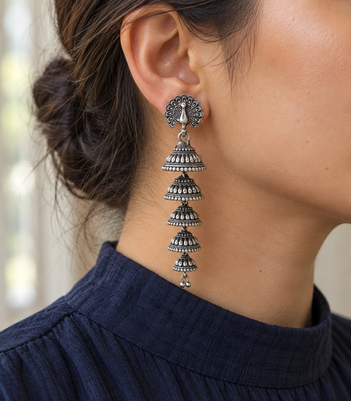 JIMIKI Peacock Five Tier Jhumka Earrings in Oxidized Silver - editorial worn view #color_oxidized-silver