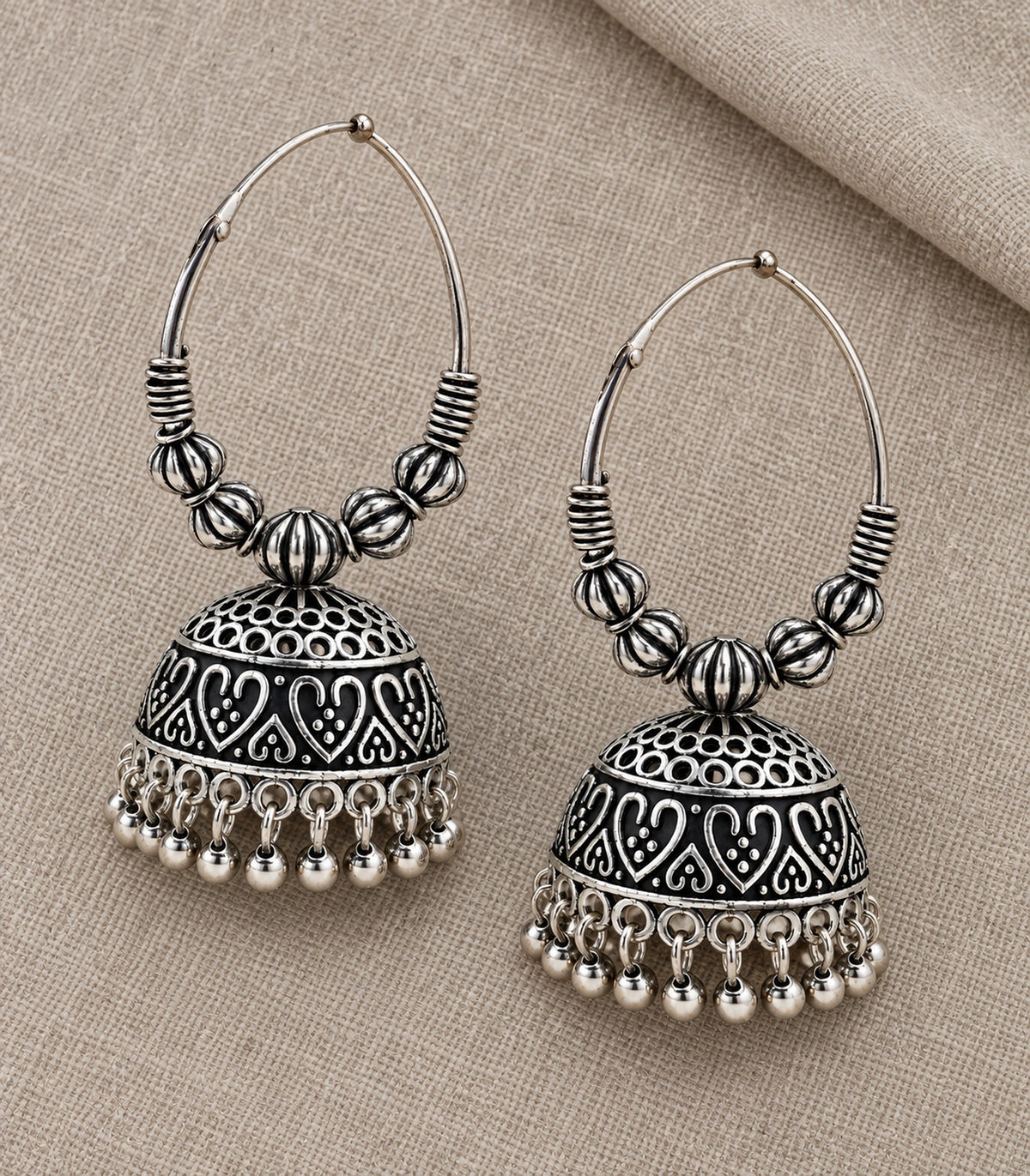 JIMIKI Oxidized Silver Ribbed Bead Hoop Heart Jhumka Earrings in Oxidized Silver - editorial flatlay #color_oxidized-silver