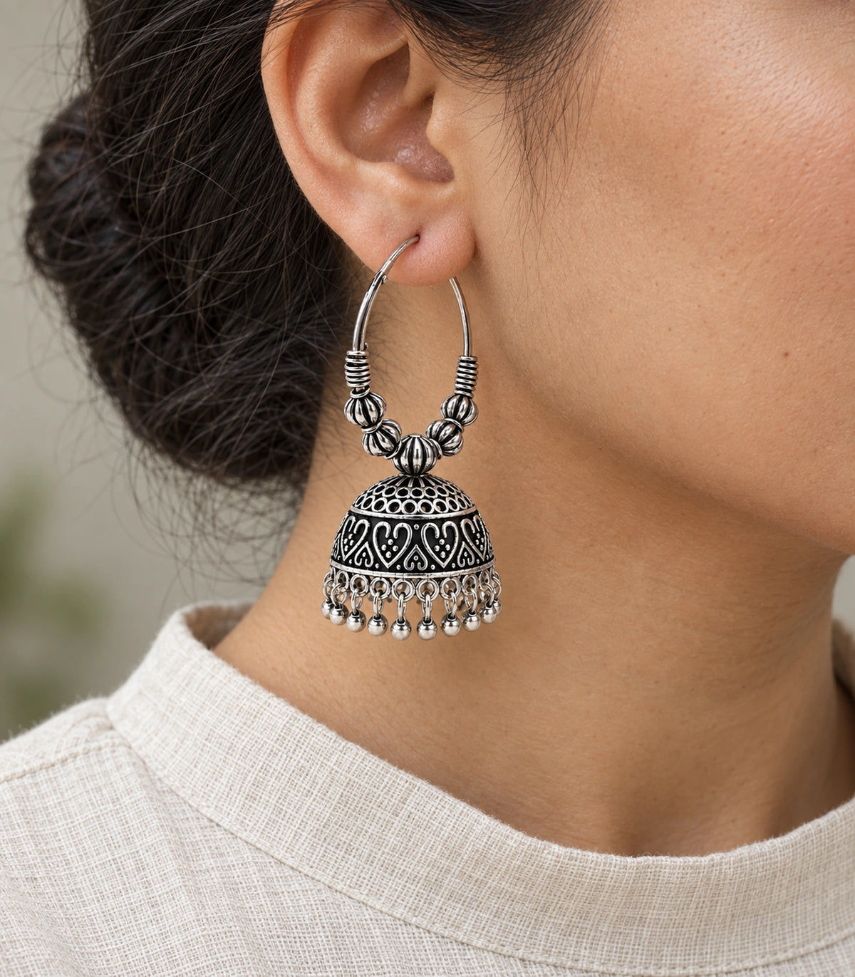 JIMIKI Oxidized Silver Ribbed Bead Hoop Heart Jhumka Earrings in Oxidized Silver - worn styling view #color_oxidized-silver