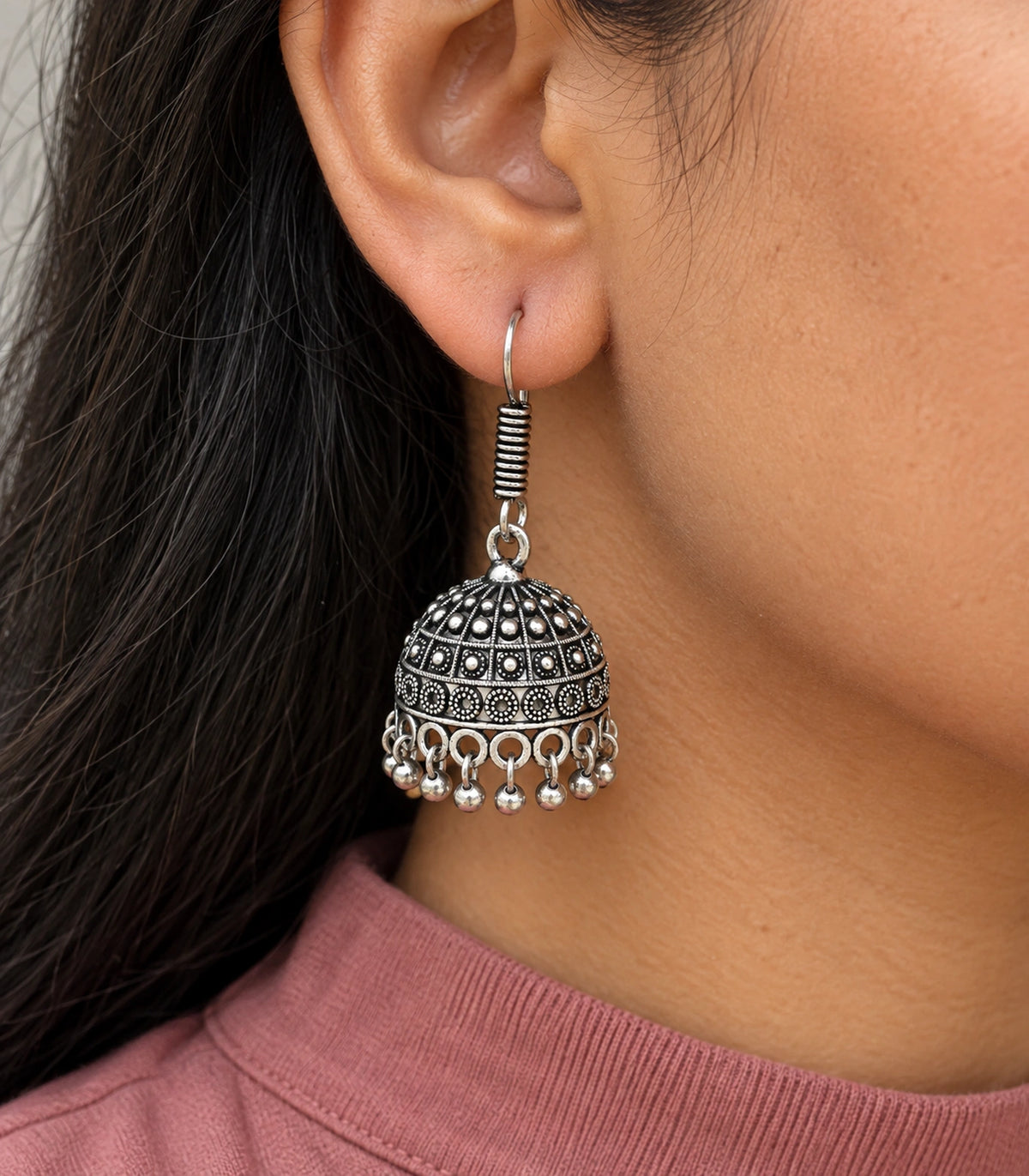 JIMIKI Oxidized Silver Rosette Grid Dome Jhumka Earrings - earring worn with a clear view of the design #color_oxidized-silver