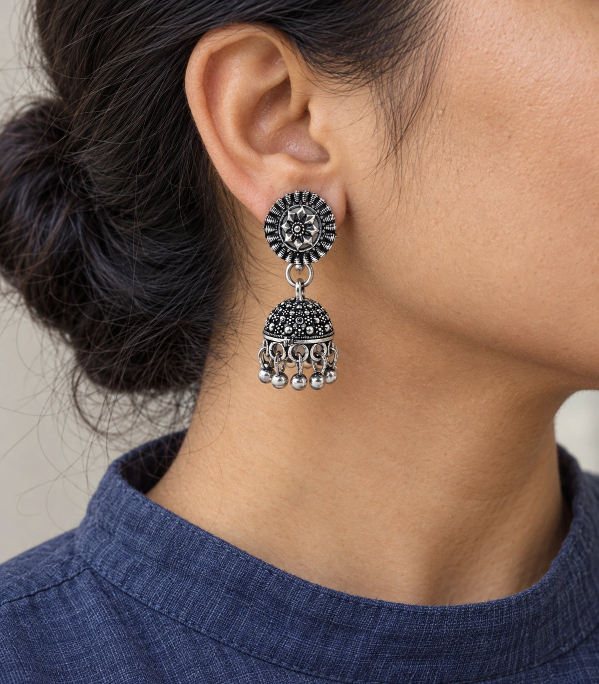 JIMIKI Oxidized Silver Rosette Stud Dotted Jhumka Earrings in Oxidized Silver - worn styling view #color_oxidized-silver