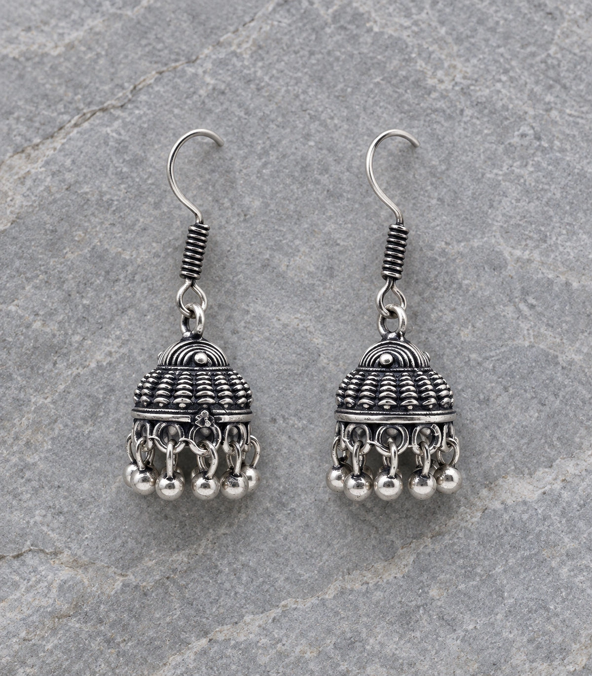 JIMIKI Oxidized Silver Scale Dome Hook Jhumka Earrings - Pair arranged in an editorial flatlay #color_oxidized-silver