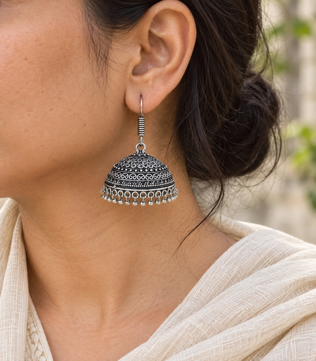 JIMIKI Oxidized Silver Scroll Dome Hook Jhumka Earrings - Oxidized Silver earring worn with a clear view of the design #color_oxidized-silver