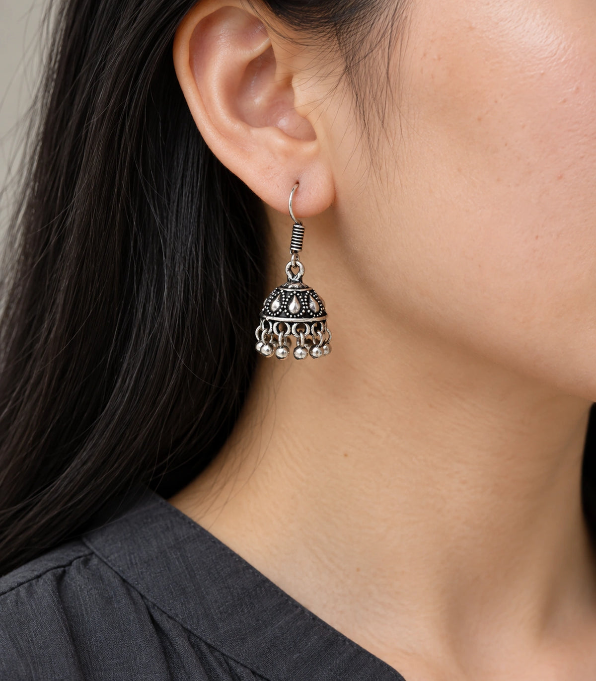 JIMIKI Oxidized Silver Teardrop Mini Jhumka Earrings - earring worn with a clear view of the design #color_oxidized-silver