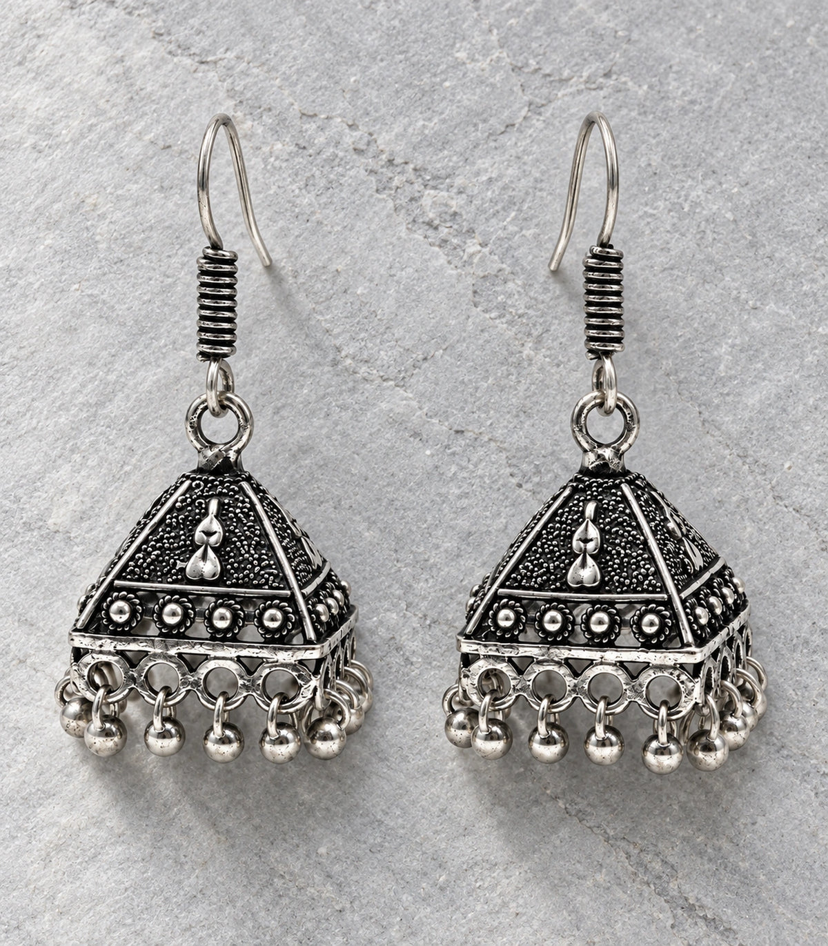 JIMIKI Oxidized Silver Teardrop Pyramid Jhumka Earrings - Pair arranged in an editorial flatlay #color_oxidized-silver