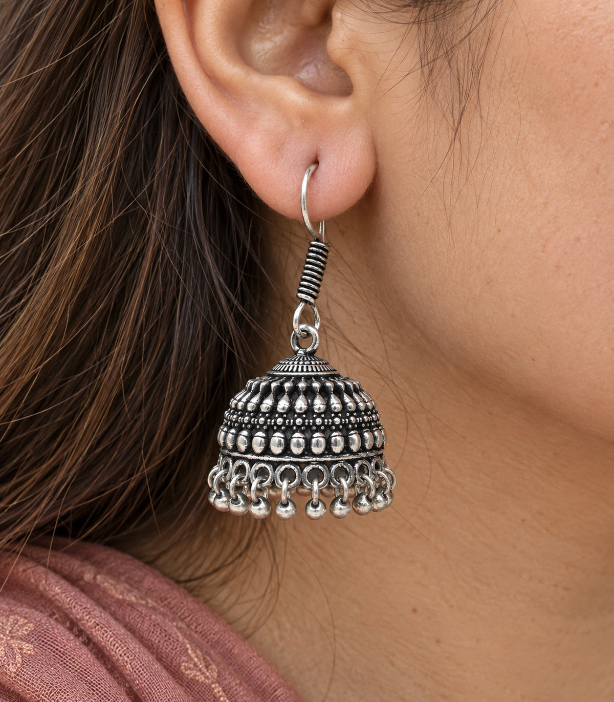 Close-up of teardrop relief bands and round fringe on oxidized silver-tone jhumkas #color_oxidized-silver