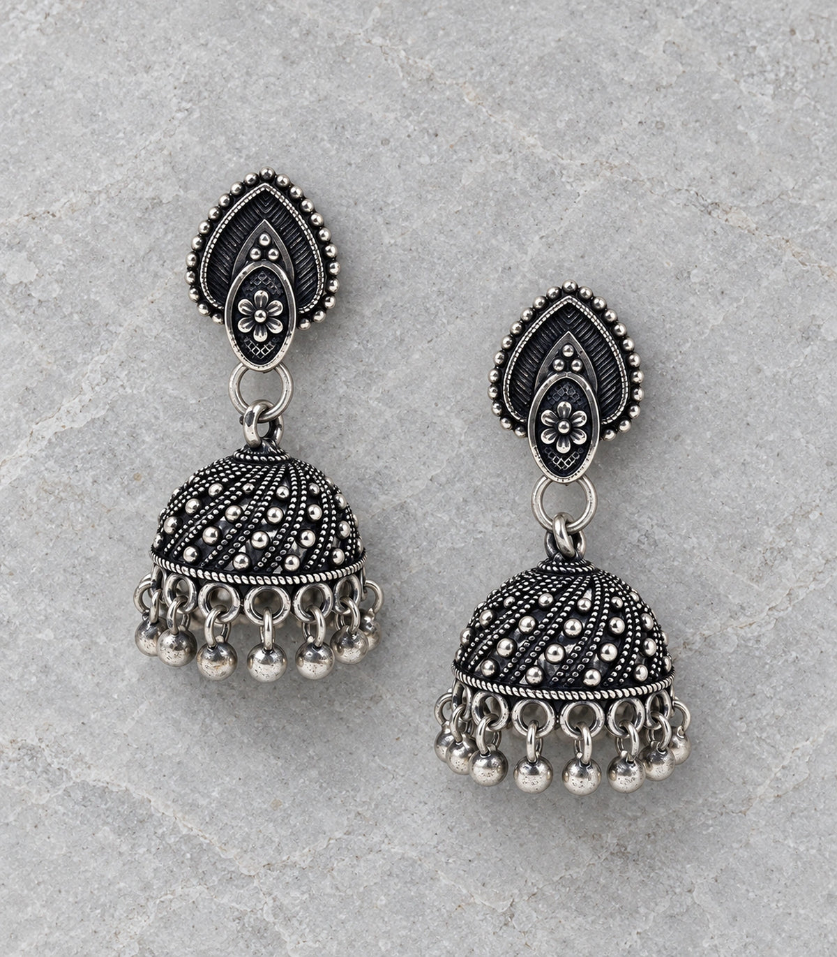 JIMIKI Oxidized Silver Teardrop Stud Dotted Dome Jhumka Earrings in Oxidized Silver - editorial flatlay #color_oxidized-silver