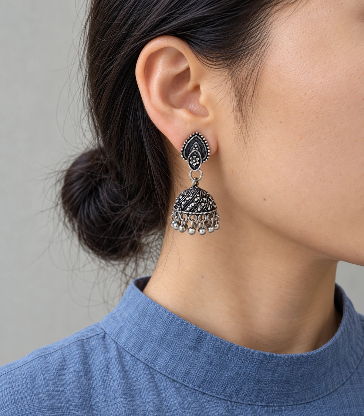 JIMIKI Oxidized Silver Teardrop Stud Dotted Dome Jhumka Earrings in Oxidized Silver - worn styling view #color_oxidized-silver
